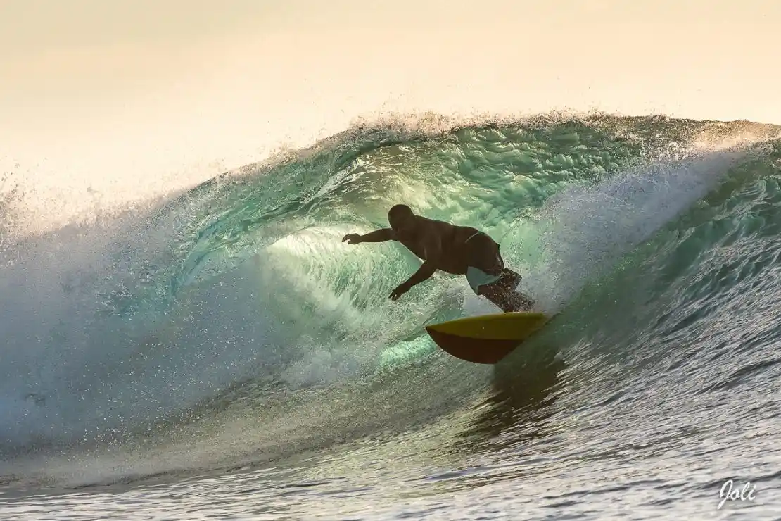 Experienced surfer tackling the famous left-hand wave at Restaurants, Fiji.