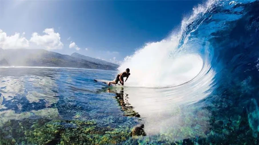 "Surfer enjoying the versatile waves at Natadola Beach, a popular Fiji surf destination.