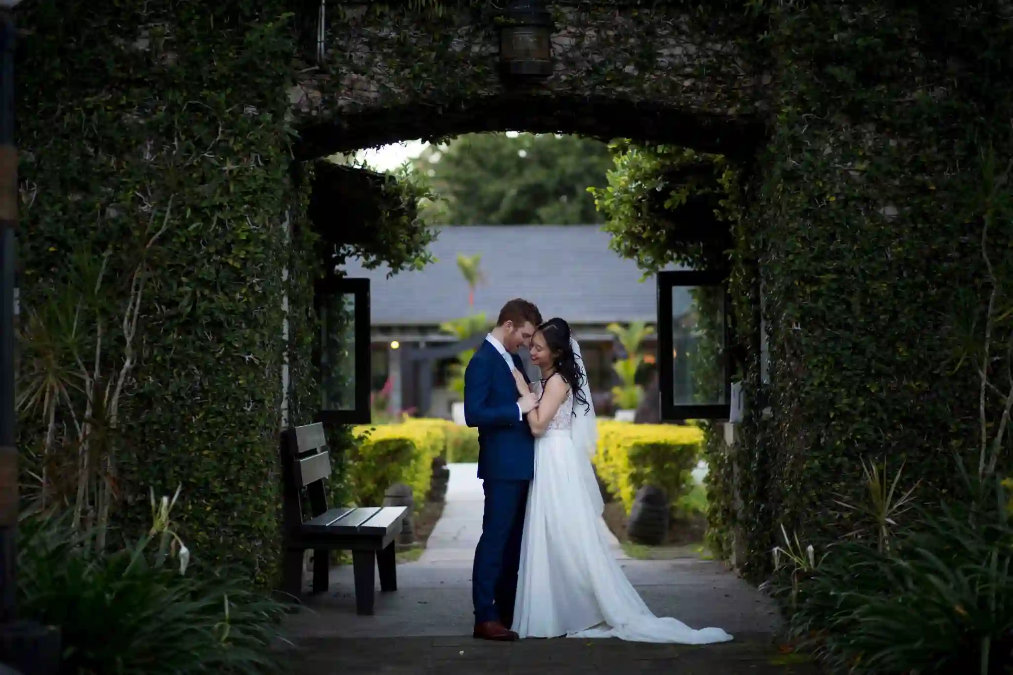 A couple embraces at the Naviti Resort archways.