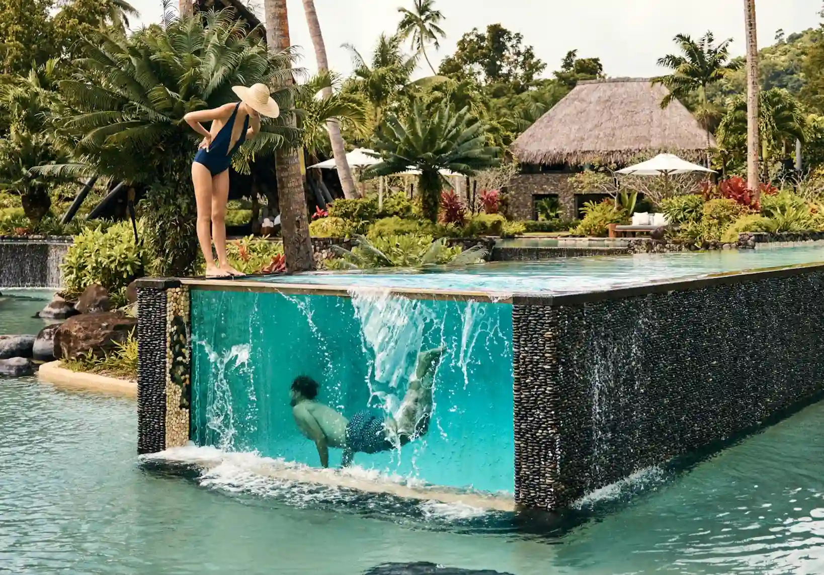 couple playfully swimming at the luxurious Laucala bay fiji