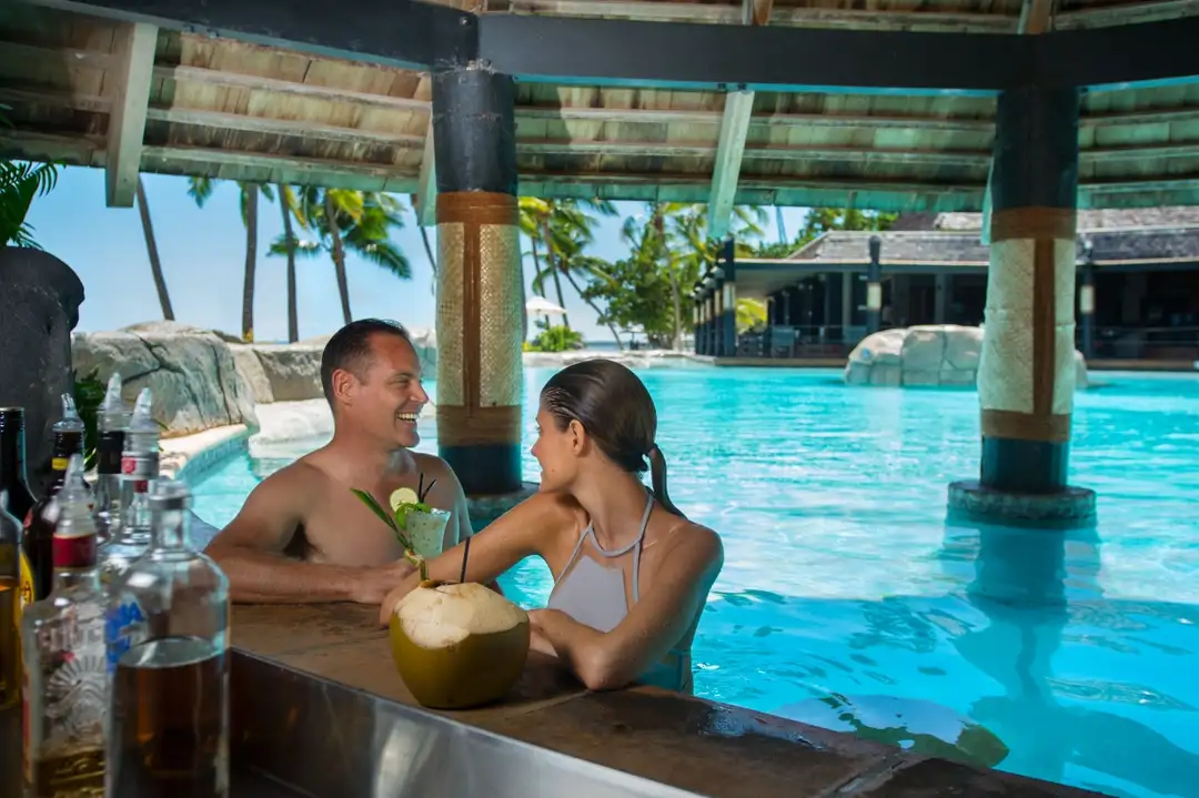 couple relaxing at poolside bar at doubletree sonaisali